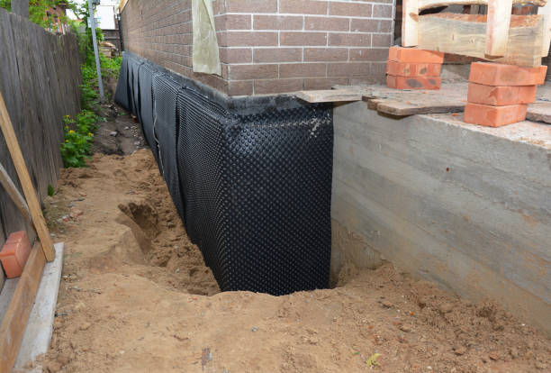 Happy homeowners after waterproofing job in Ladoga